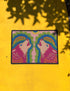 A rectangular outdoor doormat featuring a symmetrical graphic illustration of two howling wolves facing upward in profile. The design utilizes a vibrant psychedelic folk art style with a color palette of magenta pink wolves, peach muzzles, and scalloped layers of lime green and cyan blue foliage. A marigold yellow sun sits at the top center. The background is a dusty rose pink. The texture is a smooth, durable flat 2D print on polyester with a black non-slip rubber border.