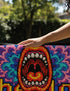 A rectangular indoor and outdoor doormat featuring a vibrant, psychedelic design. The central graphic is a large, open screaming red and orange mouth with white teeth, surrounded by highly saturated wavy, trippy patterns in blue, purple, magenta, and teal. Yellow stylized text reading HELLO is integrated into the pattern. The mat has a smooth 2D flat print surface that mimics the look of textured chainstitch embroidery, finished with a solid black fabric trim around all four outer edges.