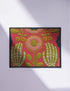 Pink outdoor doormat featuring a symmetrical folk art design. Two white skeleton hands with palms facing forward frame a large central pink and peach flower with a yellow center. Olive green stems, gold berries, and teal blue floral accents decorate the vibrant magenta background. The design mimics a textured embroidery look but is a flat 2d print. Framed with a sleek black border.