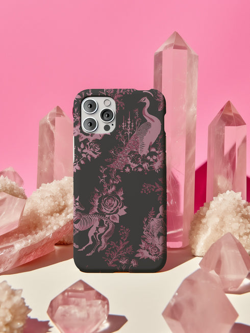 Gothic phone case featuring Victorian toile pattern in dusty rose pink on charcoal background, with skeleton unicorns, peacocks, roses, and botanical elements.
