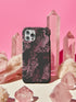Gothic phone case featuring Victorian toile pattern in dusty rose pink on charcoal background, with skeleton unicorns, peacocks, roses, and botanical elements.