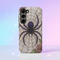 Gothic phone case featuring purple spider web design with detailed black spider on stained glass background with rose accents. Spooky Halloween phone cover with intricate web pattern and gothic aesthetic perfect for iPhone Samsung Galaxy Pixel models. Dark romantic phone protection with vintage stained glass mosaic style spider web art and floral elements.