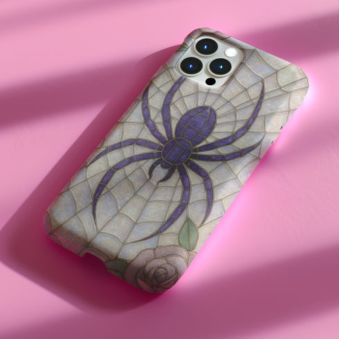 Gothic phone case featuring purple spider web design with detailed black spider on stained glass background with rose accents. Spooky Halloween phone cover with intricate web pattern and gothic aesthetic perfect for iPhone Samsung Galaxy Pixel models. Dark romantic phone protection with vintage stained glass mosaic style spider web art and floral elements.
