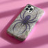 Gothic phone case featuring purple spider web design with detailed black spider on stained glass background with rose accents. Spooky Halloween phone cover with intricate web pattern and gothic aesthetic perfect for iPhone Samsung Galaxy Pixel models. Dark romantic phone protection with vintage stained glass mosaic style spider web art and floral elements.