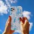 Phone case with a blue and white toile pattern featuring skeletons, owls, and floral motifs. Dual-layer protection available in glossy or matte finish.