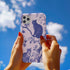 Phone case featuring a blue and pink toile pattern with cats, flowers, and botanical designs. Dual-layer protection available in glossy or matte finish.