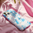 Phone case with a blue and white toile pattern featuring skeletons, owls, and floral motifs. Dual-layer protection available in glossy or matte finish.