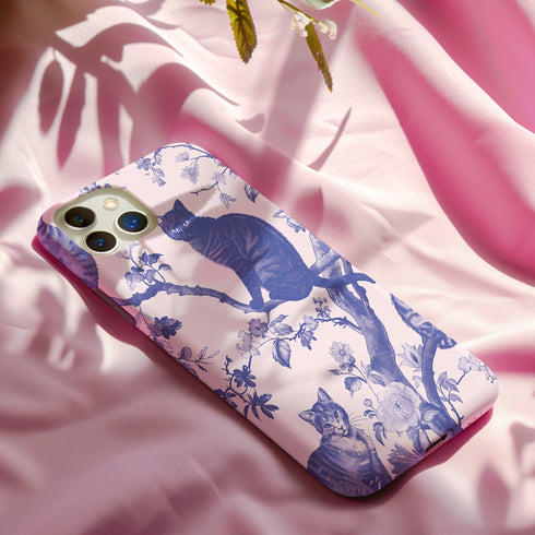 Phone case featuring a blue and pink toile pattern with cats, flowers, and botanical designs. Dual-layer protection available in glossy or matte finish.