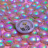 Purple button pin featuring a yellow cat wearing sunglasses and reading a book, with "Purrfectly Bookish" text curved around the edge