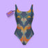 One-piece swimsuit featuring a bold 70s-inspired abstract pattern in deep navy, ochre, cream, orange, and green tones. The sculptural design creates a mirrored, psychedelic effect with curved shapes and layered swirls. Full coverage with scoop neckline and straps, ideal for retro beach looks and modern art goddesses.