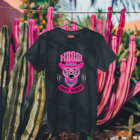 Unisex t-shirt featuring a pink tiger in purple hat and bandana, with "WHOA!" and "EASY TIGER!" text in bold retro style. Available in black and white, sizes S-3XL