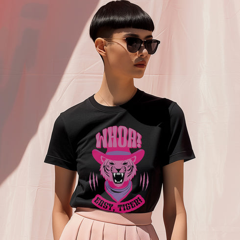 Unisex t-shirt featuring a pink tiger in purple hat and bandana, with "WHOA!" and "EASY TIGER!" text in bold retro style. Available in black and white, sizes S-3XL