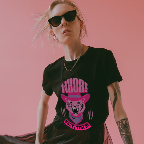 Unisex t-shirt featuring a pink tiger in purple hat and bandana, with "WHOA!" and "EASY TIGER!" text in bold retro style. Available in black and white, sizes S-3XL