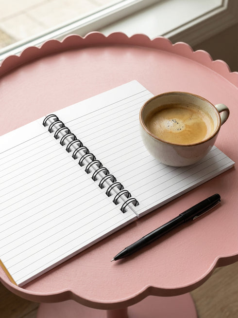 A glossy 5x7 inch spiral bound notebook featuring the phrase Inner Peace Outer Chaos in retro 70s typography. The cover showcases a vibrant psychedelic design on a mustard yellow background with a central trippy sun motif containing three mystical eyes. Below the sun, text reads Meditations, Mantras, and Meltdown Notes in bold black font. The journal has a durable black metal spiral binding and contains 150 lined pages for writing, shadow work, or daily planning.
