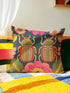 Navy blue square throw pillow cover featuring two vibrant beetles in a symmetrical design. The beetles have jewel-toned wings in emerald green and hot pink, rendered in a faux-embroidery texture style that mimics stitched threads. The background is a deep midnight blue with stylized floral accents. The texture is a smooth digital print on spun polyester. Ideal for maximalist homes and entomolgy art.