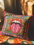 Maximalist throw pillow cover featuring a printed faux embroidery design with red open lips, pink tongue, white teeth, green scalloped medallion border, yellow and pink flowers, and decorative folk-inspired bands on a bright blue background with hot pink edging. Square colorful pillowcase for eclectic home decor, retro interiors, dopamine decor, boho living rooms, statement sofas, beds, chairs, and reading nooks.