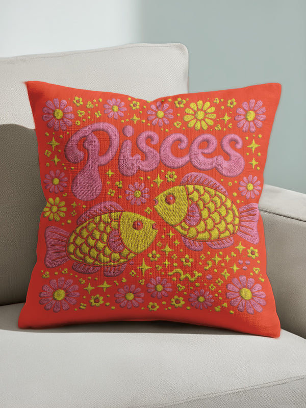 A vibrant tomato red square throw pillow featuring a retro 70s Pisces zodiac design in a faux embroidery print style. The word Pisces appears in bubblegum pink bubble letters at the top, sitting above two yellow and pink fish swimming in a circle representing the water sign. The background is densely filled with yellow and pink daisies. The texture visually mimics stitched needlework but is a smooth 2D print on linen-feel fabric. Perfect for maximalist, eclectic, and dopamine decor styles.