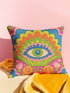 Polyester faux embroidered pillow cover featuring a bold maximalist evil eye design with a colorful folk-art inspired pattern. The front print includes a central blue, green, and pink eye surrounded by scalloped floral shapes, rainbow-like arches, leafy details, and bright decorative flowers in pink, orange, yellow, blue, and green. Soft square pillow cover with a textured woven-look print. Available in 18x18 or 22x22 inches.