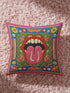 Maximalist throw pillow cover featuring a printed faux embroidery design with red open lips, pink tongue, white teeth, green scalloped medallion border, yellow and pink flowers, and decorative folk-inspired bands on a bright blue background with hot pink edging. Square colorful pillowcase for eclectic home decor, retro interiors, dopamine decor, boho living rooms, statement sofas, beds, chairs, and reading nooks.