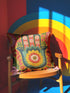 A square decorative throw pillow featuring a vibrant Hamsa hand and Evil Eye design on a hot pink background. The maximalist print includes bold blue, red, and green protection symbols with intricate details, offering a retro 70s and eclectic aesthetic. The fabric has a high-end linen texture with a hidden zipper. Available in 18x18 and 22x22 sizes.
