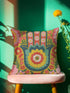 A square decorative throw pillow featuring a vibrant Hamsa hand and Evil Eye design on a hot pink background. The maximalist print includes bold blue, red, and green protection symbols with intricate details, offering a retro 70s and eclectic aesthetic. The fabric has a high-end linen texture with a hidden zipper. Available in 18x18 and 22x22 sizes.