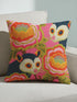 A square linen-feel throw pillow with a vibrant, maximalist print on a bright pink background. The pattern features two large, illustrated possums (or sugar gliders). The animals are nestled amongst large, 70s-style retro floral designs in shades of orange, marigold yellow, and turquoise, with avocado green leaves. The pillow has a textured, woven appearance, mimicking a high-end linen fabric. The double-sided print is colorful, eclectic, and groovy, with a distinct vintage 70s folk art feel.
