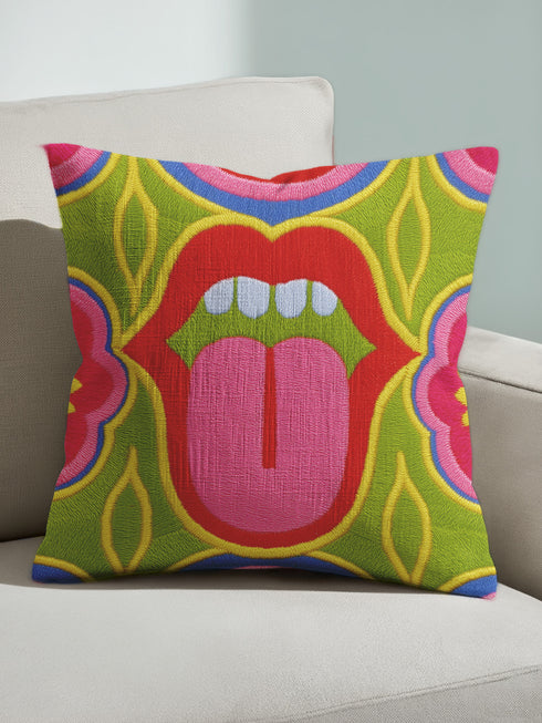 A square decorative throw pillow cover featuring a bold, symmetrical pop art design of an open mouth with bright red lips, white teeth, and a pink tongue sticking out. The central graphic is set against a lime green background surrounded by abstract geometric and floral shapes in vibrant hues of pink, yellow, and cornflower blue. The fabric has a visible premium linen-like woven texture. The colorful retro illustration is printed on both sides of the pillowcase.