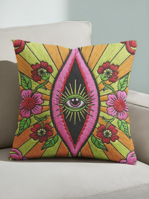 Black square pillow cover with a central eye medallion set inside a pink almond shaped mandorla. The psychedelic design surrounds the eye with red floral motifs, green leaves, and radiant orange and yellow sunburst rays. The smooth, linen-feel polyester print mimics high fidelity embroidery texture with no raised stitching. Divine feminine and sacred feminine eye pillow case, a feminist maximalist and whimsigoth cushion cover on a bold high-contrast black ground.