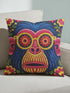 quare throw pillow cover with a faux embroidery 2D print of a stylized monkey face in large round yellow sunglasses with red flower lenses. The ape has electric blue fur with a hot pink brow and nose, on a navy background scattered with hot pink, yellow, and red flowers and green leaves. The print mimics raised stitching while staying flat and smooth, and shows on both sides. Cover only, available in 18 by 18 inch and 22 by 22 inch sizes.