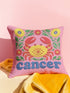 A square pink pillowcase features a vibrant, multi-colored design centered around a yellow and red crab representing the Cancer zodiac sign. The design is framed by symmetrical green leaves and yellow and red flowers. The word "cancer" is written in a bold, blue, rounded font at the bottom. The visual texture mimics intricate raised embroidery with visible stitch patterns, though the surface is a smooth 2D print on a linen-textured polyester fabric with a hidden zipper.
