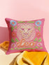 Maximalist throw pillow for the Leo zodiac sign featuring a centralized lion head medallion with an ornate mane mimicking embroidered textures. The background is a vibrant hot pink, accented by ochre, rust, and lime green floral motifs and blue flowers in each corner. The pillow is square with a hidden zipper and a polyester insert. This high-contrast design is a perfect fit for dopamine decor, whimsigoth apartments, or any eclectic home looking for a bold astrology-inspired statement piece.