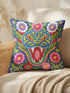Square throw pillow cover with a faux embroidery 2D print of a stylized folk-art serpent with a blue head, yellow swirl markings, red eyes, white fangs, and an open red mouth. It is surrounded by pink, purple, and white flowers with yellow centers and green leaves on a deep blue background. The print mimics raised stitching while staying flat and smooth, and shows on both sides. Cover only, available in 18 by 18 inch and 22 by 22 inch sizes.