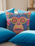 quare throw pillow cover with a faux embroidery 2D print of a stylized monkey face in large round yellow sunglasses with red flower lenses. The ape has electric blue fur with a hot pink brow and nose, on a navy background scattered with hot pink, yellow, and red flowers and green leaves. The print mimics raised stitching while staying flat and smooth, and shows on both sides. Cover only, available in 18 by 18 inch and 22 by 22 inch sizes.