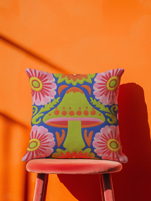 A square throw pillow cover featuring a detailed maximalist baroque mushroom design on a dark background. The pattern displays vibrant orange, red, and purple toadstools intertwined with green ferns and vintage botanical foliage. The style combines dark cottagecore with psychedelic art. The fabric possesses a premium linen texture visible in the close-up. The print appears on both sides. A hidden zipper sits at the bottom seam. The pillow is shown as a case only without an insert inside.