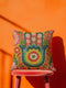 A square decorative throw pillow featuring a vibrant Hamsa hand and Evil Eye design on a hot pink background. The maximalist print includes bold blue, red, and green protection symbols with intricate details, offering a retro 70s and eclectic aesthetic. The fabric has a high-end linen texture with a hidden zipper. Available in 18x18 and 22x22 sizes.