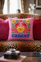 A square pink pillowcase features a vibrant, multi-colored design centered around a yellow and red crab representing the Cancer zodiac sign. The design is framed by symmetrical green leaves and yellow and red flowers. The word "cancer" is written in a bold, blue, rounded font at the bottom. The visual texture mimics intricate raised embroidery with visible stitch patterns, though the surface is a smooth 2D print on a linen-textured polyester fabric with a hidden zipper.