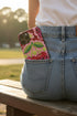 Dual layer matte phone case with a high fidelity 2D print that creates a hyper realistic faux crochet and knit illusion. The central design shows two conjoined cherries styled as bright pink and burgundy human skulls with lime green stems and leaves. The background is a detailed scalloped lace doily pattern in hot pink, deep red, and lime green. Matte finish shell with a black inner TPU lining, precise camera cutout, and open ports. Pastel goth macabre alt fashion phone accessory, made to order.