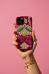 Dual layer matte phone case with a high fidelity 2D print that creates a hyper realistic faux crochet and knit illusion. The central design shows two conjoined cherries styled as bright pink and burgundy human skulls with lime green stems and leaves. The background is a detailed scalloped lace doily pattern in hot pink, deep red, and lime green. Matte finish shell with a black inner TPU lining, precise camera cutout, and open ports. Pastel goth macabre alt fashion phone accessory, made to order.