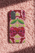 Dual layer matte phone case with a high fidelity 2D print that creates a hyper realistic faux crochet and knit illusion. The central design shows two conjoined cherries styled as bright pink and burgundy human skulls with lime green stems and leaves. The background is a detailed scalloped lace doily pattern in hot pink, deep red, and lime green. Matte finish shell with a black inner TPU lining, precise camera cutout, and open ports. Pastel goth macabre alt fashion phone accessory, made to order.