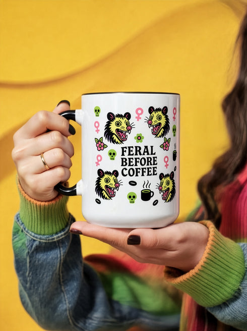 Possum Feminist Feral Before Coffee Mug features snarling possum heads, skulls, and feminist icons. Ideal for non-morning people and neurodivergent individuals, this sassy, dishwasher-safe mug suits those embracing chaos and self-expression.