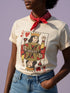 A centralized graphic design of a Queen of Hearts playing card on a cream or pink unisex t-shirt. The Queen is depicted in a maximalist folk art style, holding a heart-topped scepter and a raised fist in a gesture of solidarity. The word "RESIST" is visible on her crown and a central banner in ochre and true red tones. The layout is a centralized medallion style with rust and ochre accents and a playing card border.