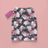 High-waisted bodycon mini skirt featuring abstract floral print in coral pink, white and charcoal grey on black background. Fitted silhouette with stretch fabric and above-knee length.