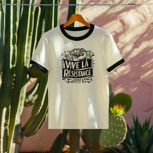 White and black ringer tee with a bold “Vive La Résistance” graphic, featuring a raised fist illustration and a vintage protest style.
