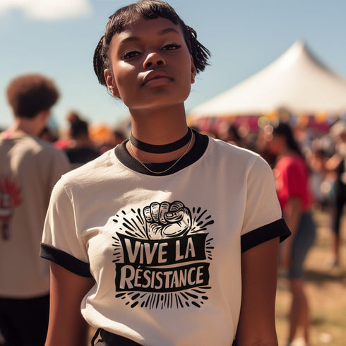 White and black ringer tee with a bold “Vive La Résistance” graphic, featuring a raised fist illustration and a vintage protest style.