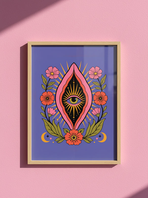 A vertical art print featuring a central pink yoni shape with a black interior containing a single eye. Golden yellow sun rays radiate from the center against a solid periwinkle blue purple background. The central motif is surrounded by a symmetrical botanical border of pink and red daisy flowers and green leaves, with two yellow crescent moons in the bottom corners. Printed on flat museum grade matte paper. This is the printed artwork only; a frame is not included. Ready to frame.