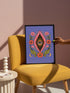 A vertical art print featuring a central pink yoni shape with a black interior containing a single eye. Golden yellow sun rays radiate from the center against a solid periwinkle blue purple background. The central motif is surrounded by a symmetrical botanical border of pink and red daisy flowers and green leaves, with two yellow crescent moons in the bottom corners. Printed on flat museum grade matte paper. This is the printed artwork only; a frame is not included. Ready to frame.