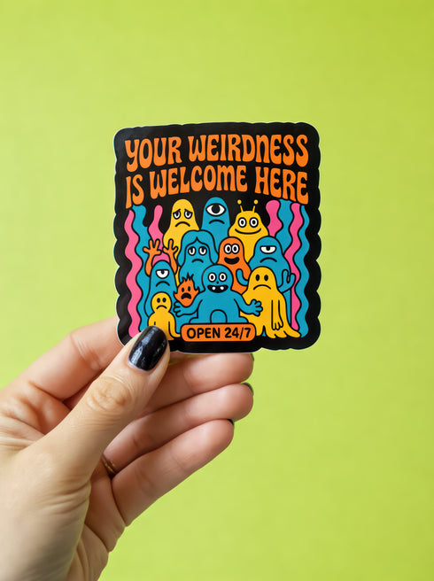 A person holds the Retro Monster Sticker - 70s Groovy Decal | Colorful Monster Art for Self Acceptance, showcasing quirky monster creatures with the message YOUR WEIRDNESS IS WELCOME HERE. Ideal for celebrating individuality and neurodiversity.