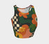 Cropped racerback tank top featuring bold retro floral print with orange and yellow mod flowers, green leaves, black and white checkerboard pattern, and abstract wavy designs. Fitted athletic style crop top in vibrant 70s inspired botanical print with performance fabric construction. Women's festival rave wear cropped camisole with psychedelic flower power design perfect for summer concerts, Y2K fashion looks, and alternative streetwear styling.