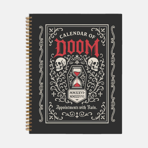 An 8.5 x 11 inch black hardcover spiral planner with a durable satin matte laminated finish. The front cover features a vintage-style white ornamental border, creating a gothic, macabre aesthetic. Inside the frame, the title "Calendar of Doom" is printed in an antique serif font. This undated weekly and monthly agenda is shown with a metal wire-o spiral binding on the right side. The design uses a black, white, and red color scheme, making it a unique piece of dark humor stationery