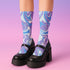 Psychedelic ankle socks featuring a bold blue and purple marble swirl pattern with black reinforced heel and toe, made from a stretchy polyester, nylon, and spandex blend, one size fits most, unisex, vibrant statement accessory for alternative and festival fashion lovers.